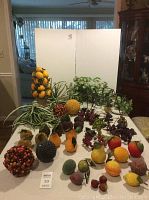 Full lot on table showing lemon topiary, artificial greenery, berry balls, and assorted beaded fruit pieces arranged.