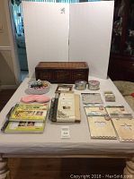 Full layout of lot items on a table showing storage unit, washi tapes, albums, calendars, and craft supplies.