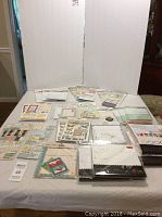 Wide shot showing full assortment of journaling inserts, stickers, pockets, and themed cardstock sheets on table