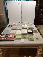 Photo showing multiple packs of invitation enclosures, pockets, envelopes in various colors and sizes arranged on a table.