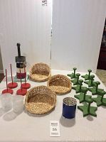 Overview photo showing all items: green star hooks, wicker baskets, red spindles, tape rolls, candle holders, and pen cup