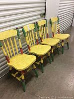 Four yellow wooden chairs aligned side by side showing front and side views.