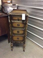 Green small cabinet on casters with four drawers visible from front.