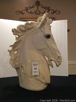 Front and right side view of large horse head sculpture bust showing detailed mane and facial features.