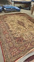 Full view of large 9'x12' area rug with ornate oriental design, showing pattern and condition.