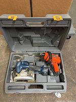 Photo of open plastic case containing Ryobi cordless circular saw and Kmart corded drill