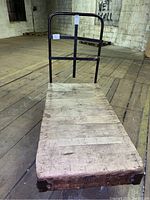 Full view of cart from above showing the wooden platform base and metal frame handle.