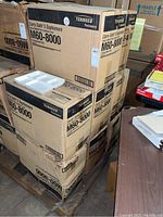 Stacked cardboard cartons labeled Carry-Safe M60-8000 on a pallet with one tray on top