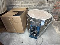 Full view showing Skutt kiln and cardboard box labeled kiln tools next to it.