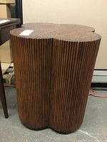 Full view of the wooden dowel side table showing the clustered dowels making up the vertical sides and the top surface.