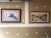 Full view of both framed prints, showing aircraft and frames