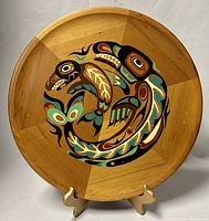 Front view of the 16-inch round red cedar wood wall plaque with colorful Native American style killer whale design painted in the center.