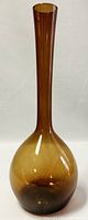 Front view of tall amber glass vase showing elongated neck and rounded base