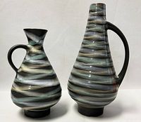 Two West German jug vases with striped glaze pattern, shown upright side by side.