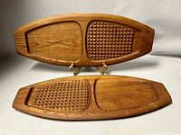 Photo showing both teak cheeseboards positioned side by side, highlighting the dual-section design with one textured and one smooth area on each board.