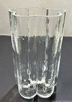 Front view of clear textured glass vase with wavy lobed shape