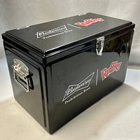Black metal cooler with Budweiser Prohibition Brew and Ruffles logos, side handles, metal latch clasp, and bottle opener.