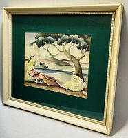 Front view of framed lithograph print showing scene with woman, tree, houses and landscape under glass and cream-colored frame.