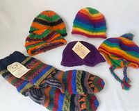 Handmade colorful wool hats and striped socks laid flat for full view.