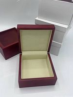 Photo showing open reddish brown box with cream interior to illustrate box design and interior material.