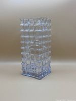 Clear glass square vase with block pattern texture on all sides, photographed at an angle.