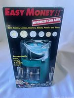 Photo of Easy Money II motorized coin bank in original box showing front with branding and sorting coins illustrations