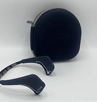 Black Muse brain-sensing headband shown next to its black zippered soft carrying case with embossed logo.