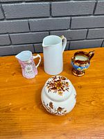Top view of four porcelain pieces with the ginger jar in front
