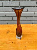 Full view of the vintage amethyst vase showing tall slender body and flared top with clear glass base.