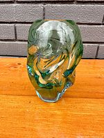 Front angle view of the green and clear Murano glass vase showing swirling design inside.