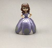 Front view of the small Sofia The First action figure in purple dress and tiara.