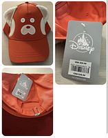 Front view of the orange baseball hat with panda face and ears made from fabric and buttons.