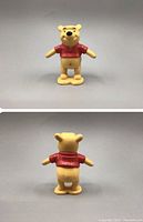 Front and rear views of vintage Disney Winnie The Pooh figure standing on a yellow base, wearing a red shirt.