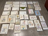 Flat layout of 30+ pieces of Betsy Clark stationery including envelopes, cards, and paper with vintage children's illustrations in pastel colors.