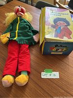 Full view of Pelham Ventriloquist Puppet V6 Fido lying on table next to original box.