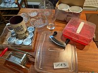 Various kitchen items including microwave glass tray, vintage potato cutter, jam jars, mug, muffin case, pressed glass, vases, soup bowls