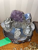 View of entire nativity display showing the agate base, amethyst crystals, quartz, and pewter figurines placed in a typical nativity scene arrangement.