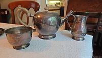 Overview of teapot, creamer and sugar bowl on table