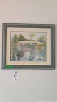 Full view of the framed watercolour painting depicting a bridge over a river with reflected trees.