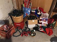 Photo showing multiple green string lights coiled in wooden crates and boxes with gift bags and decorations in background