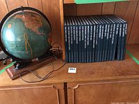 Photo showing the illuminated globe and the full set of Epic Flight Time Life books lined up together.