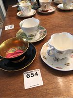 Overall view of three teacup and saucer pairs on table