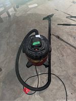 Shop Vac showing the tank body, hose, and handle with attached extension wand and floor nozzle.