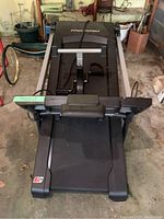 Front view of the black Pro-Form treadmill with visible control panel, safety key, and running belt.