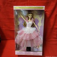 Full front view of Barbie Flower Ballerina doll in original packaging with visible pink and white dress and clear plastic box front.