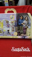 Front of original sealed box showing kitchen playset and three dolls