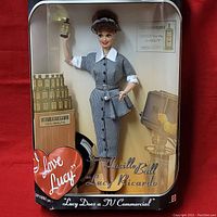 Front view of Mattel I Love Lucy Barbie doll in box with full outfit and accessories visible