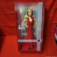Full front view of the Barbie doll in original box showing red gown, box design with Go Red for Women and American Heart Association logos.