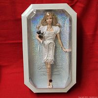 Full view of Mattel Birthstone Beauties Miss Diamond Barbie doll in original packaging on a red background.