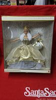 Front view of Mattel Celebration Barbie Special 2000 doll in original packaging, showcasing the doll in a gold and white glittery gown with accessories.